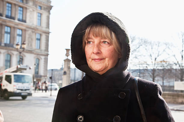 istock mature woman in black winter coat 185329561