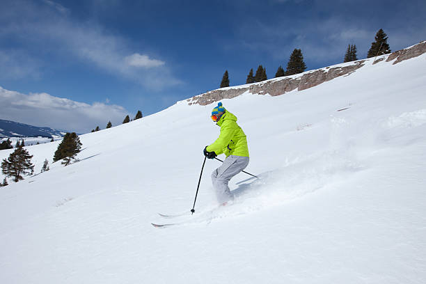 Young male skiing the light powder, Colorado, USA stock photo