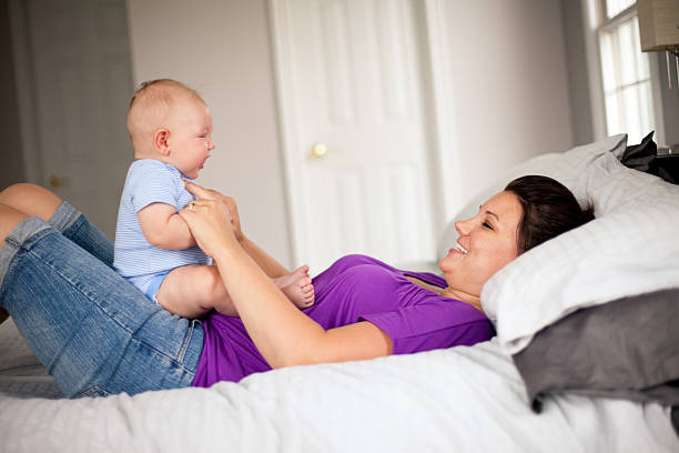istock Young Mother Looking at Her Cute Baby Boy and Smiling 185329732