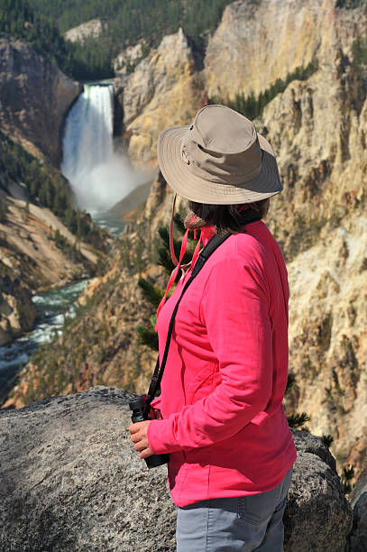 istock Tourist looking at Yellowstone waterfall 185329887