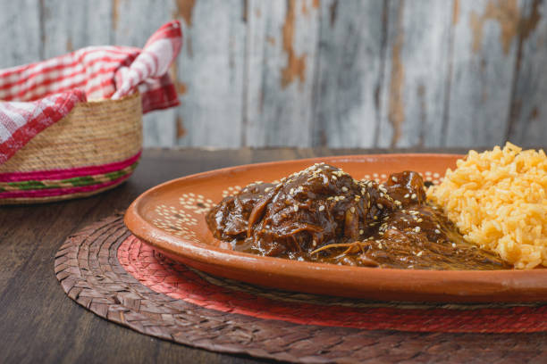 istock Mole, typical Mexican food. Traditional Mexican dish served in a clay dish. 1853300196