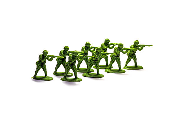 Very Tiny Very small toy plastic soldiers on a white background. toy soldier stock pictures, royalty-free photos & images