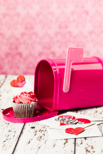 Mailbox with a Valentine's cupcake inside which has a tiny love letter on top. 
