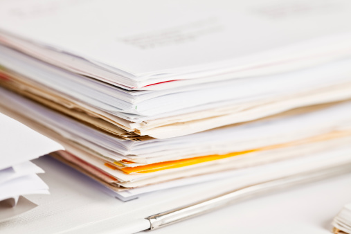 Stack of paper sheets against blurred background, closeup