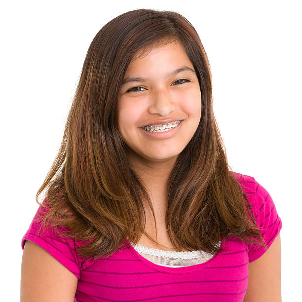 Smiling Teenage Girl With Braces Portrait of a teenage girl on a white background. http://s3.amazonaws.com/drbimages/m/dr.jpg cute 15 year old girls stock pictures, royalty-free photos & images