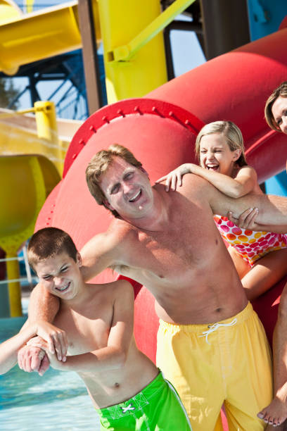 istock Man with family at water park 185330736