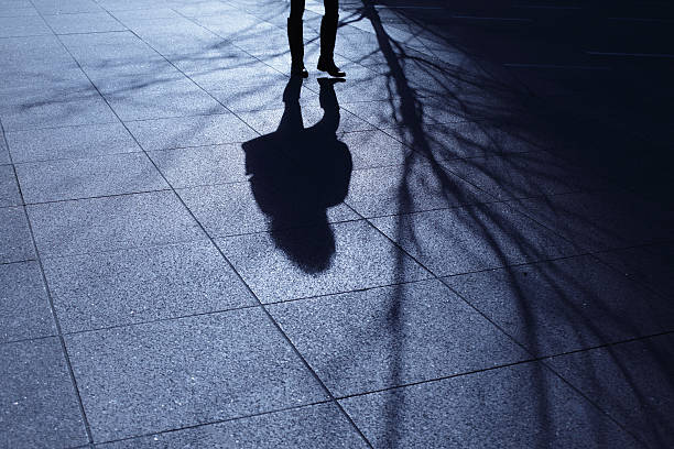 istock Lone female walking in blue night shadows 185331941