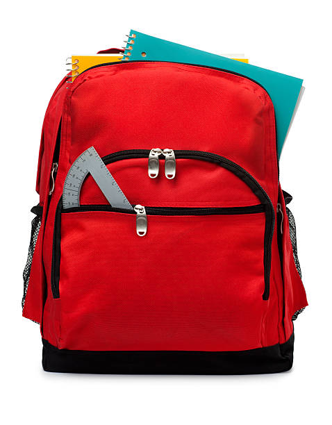 Backpack Isolated on a White Background This is a photo of a red backpack with school supplies isolated on a white background. rucksack stock pictures, royalty-free photos & images