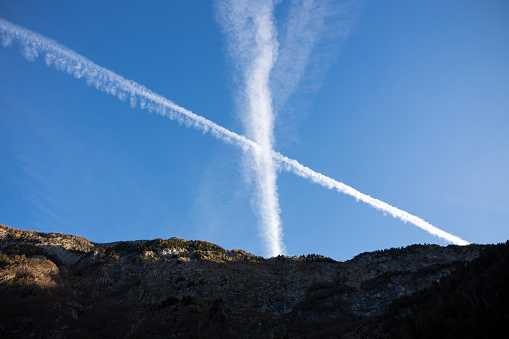 Two Aircraft Contrail Pollution over Blue Sky in Mountains Environment - European Alps