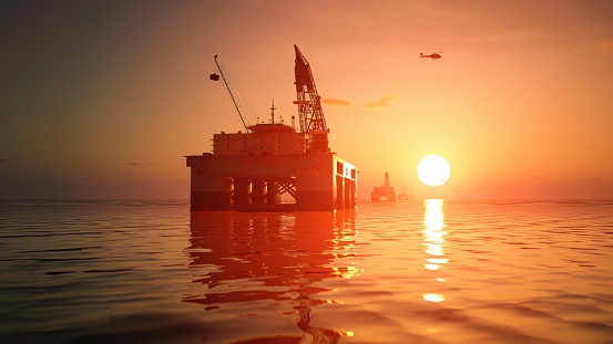 Bow of a ship against the waves and reflections of a sunset.