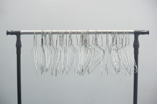 old Clothes-pegs in front of a white wall (copy space)