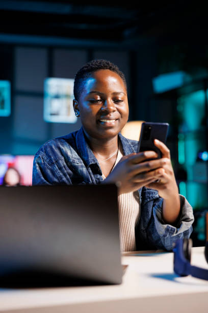 istock Black woman texting on her mobile phone 1853405049