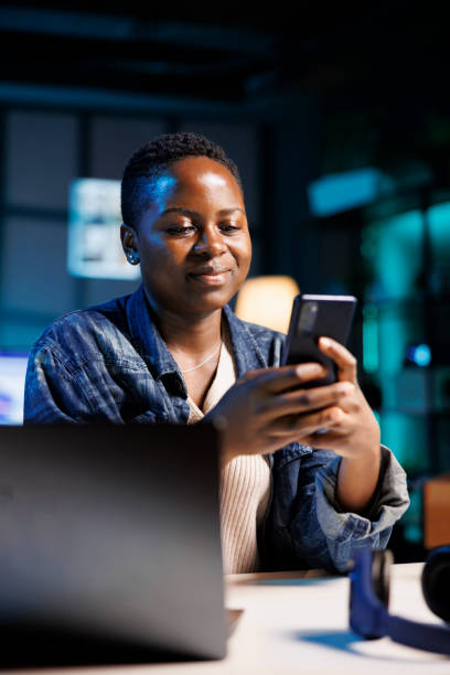 istock Young woman types a message on her phone 1853406066
