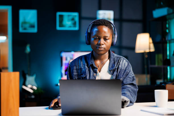 istock Woman with Digital Laptop and Headset 1853411655