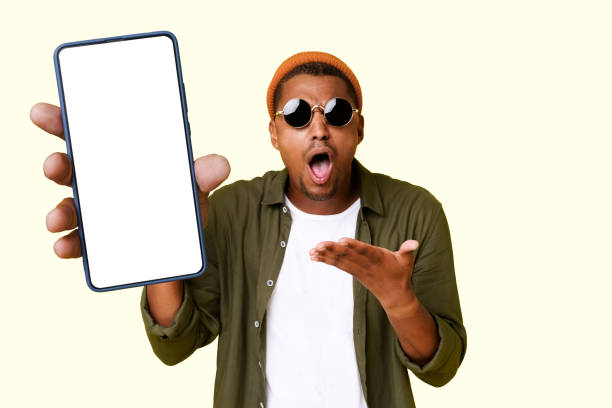 istock Surprised Exited Man Offers Advertising Proposition To Customer For Mobile App Or Internet Usage. 1853424975