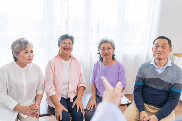 senior females and male sitting on bench. older people are listening and enjoy meeting focus group at living room. joyful carefree retired senior friends enjoying relaxation at nearly home. - senior adult human face male action imagens e fotografias de stock