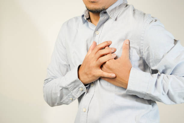 istock the man pressed his chest with a painful expression. Severe heartache, having a heart attack or painful cramps, heart disease 1853510262