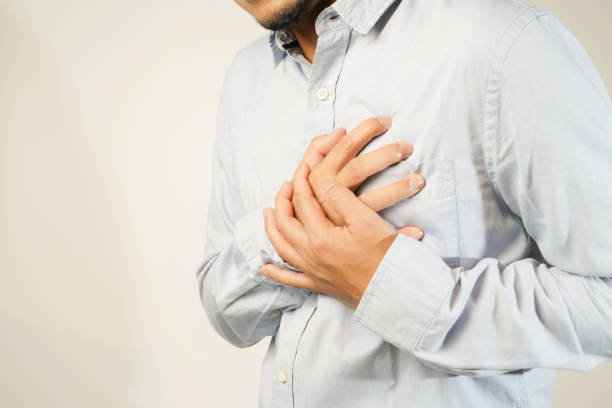 istock the man pressed his chest with a painful expression. Severe heartache, having a heart attack or painful cramps, heart disease 1853519480