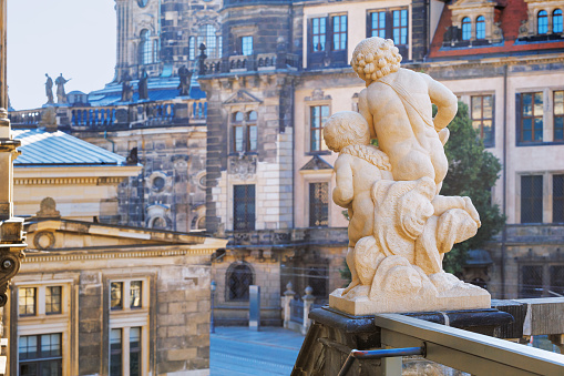 Cityscape - view of the sculpture of a pair of cupids against the backdrop of Dresden Castle close-up, Dresden, Saxony, Germany, 4 July, 2022