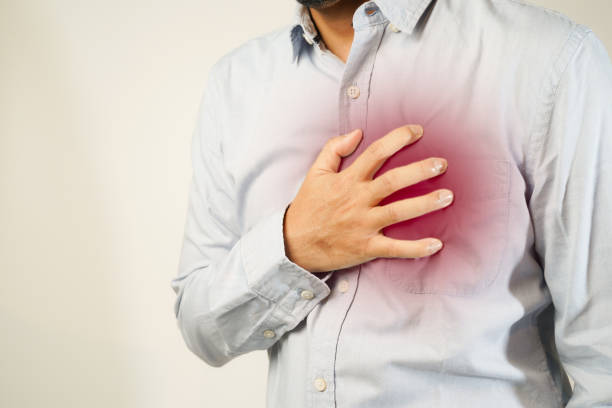 istock the man pressed his chest with a painful expression. Severe heartache, having a heart attack or painful cramps, heart disease 1853520524