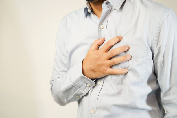 istock the man pressed his chest with a painful expression. Severe heartache, having a heart attack or painful cramps, heart disease 1853520529