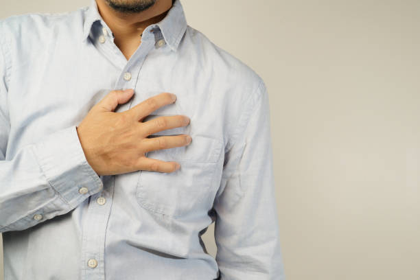 istock the man pressed his chest with a painful expression. Severe heartache, having a heart attack or painful cramps, heart disease 1853521046