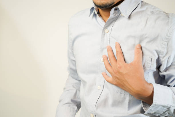 istock the man pressed his chest with a painful expression. Severe heartache, having a heart attack or painful cramps, heart disease 1853522067