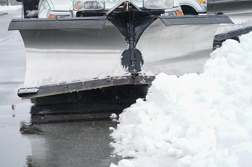 truck with snowplow installed in the parking lots
