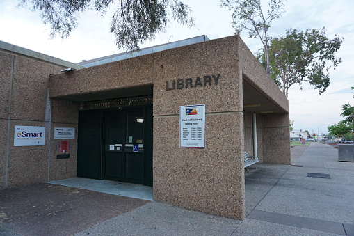 Exterior street entrance of Mount Isa City Library on West St including sign with opening hours, Mt Isa, Queensland, Australia
