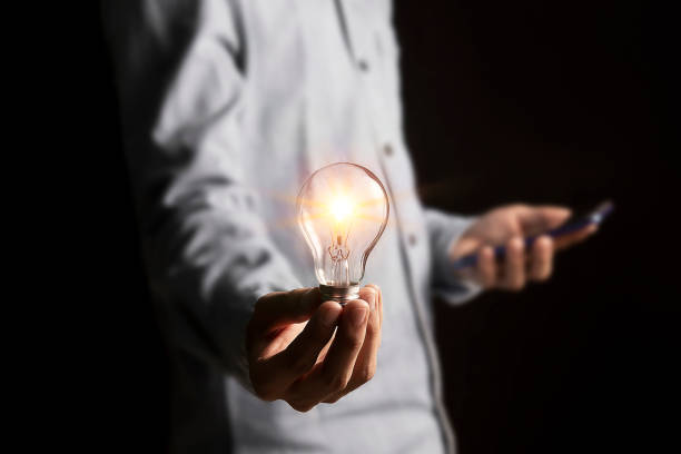 istock businessman holding an innovative light bulb creating new ideas inspirational ideas and problem solving 1853823941
