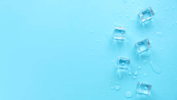 istock Concept of cold and refreshing. Ice cubes with water drops on a blue background. 1853824474