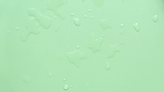 Water drops over a green background for creative poster design.