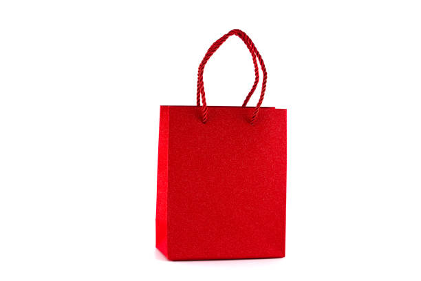 Red paper shopping bag isolated on white background. Gifts and shopping concept