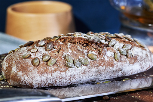 Healthy lifestyle. Wholegrain bread with gluten free grains on wooden background, copy space