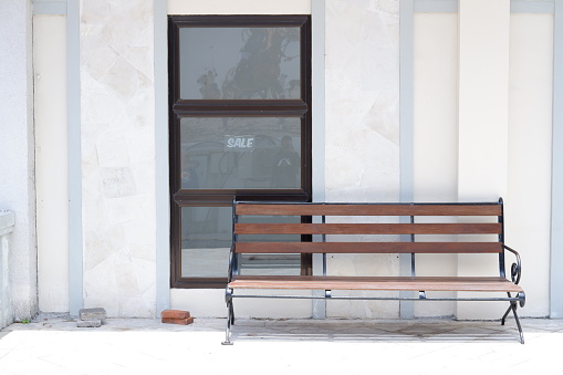 Wooden bench in front of the entrance to the building, stock photo