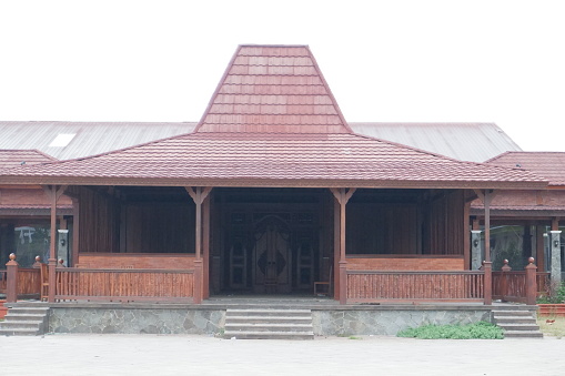 Old wooden house with a roof of the building in the village.