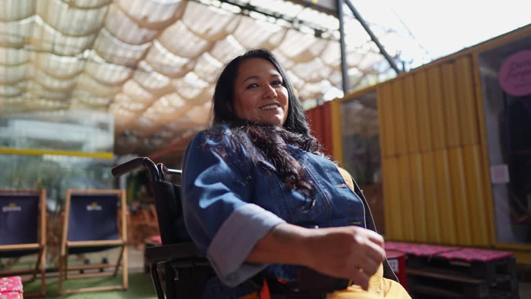 Portrait of a wheelchair mature woman at bar or restaurant