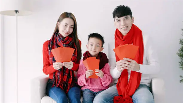 happy chinese new year. asian family showing red envelope for celebrating chinese new year