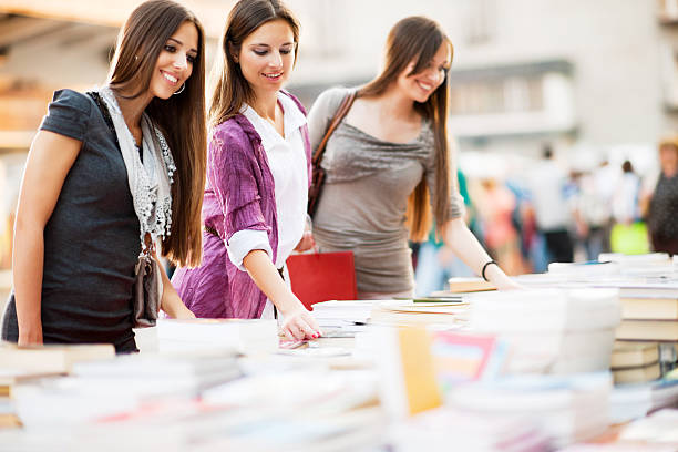 istock Young women buying books. 185405298