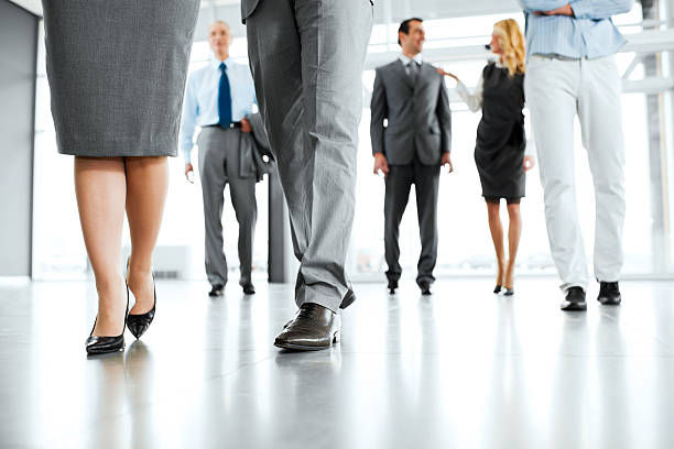 istock Group of professionals walking in a building 185405330