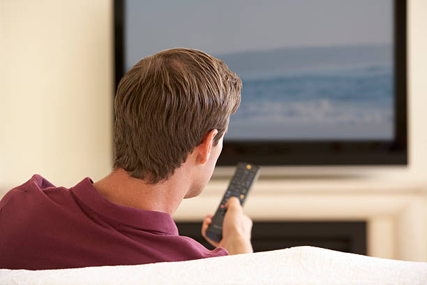 istock Man Watching Widescreen TV At Home 185405438
