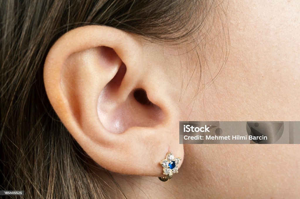 Human Ear Macro of a little girl ear. Great detail. Earring Stock Photo