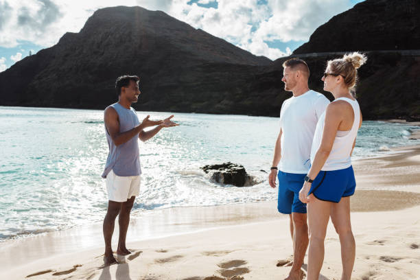 istock Heath coach meeting with clients on beach 1854055970