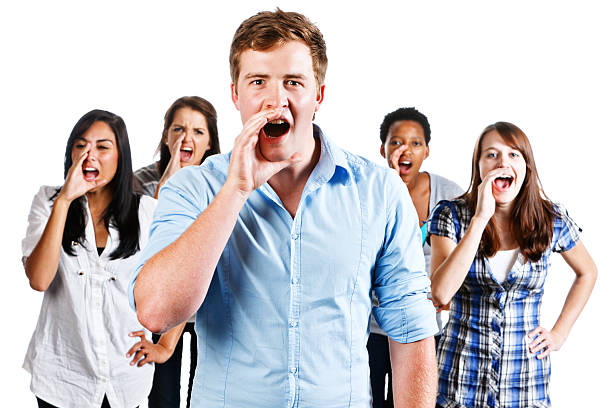 Screaming man in black t-shirt holding his head making a freak-out face looking at the camera