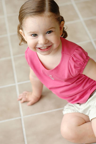 istock Cute Little Girl on Tile Floor 185406339