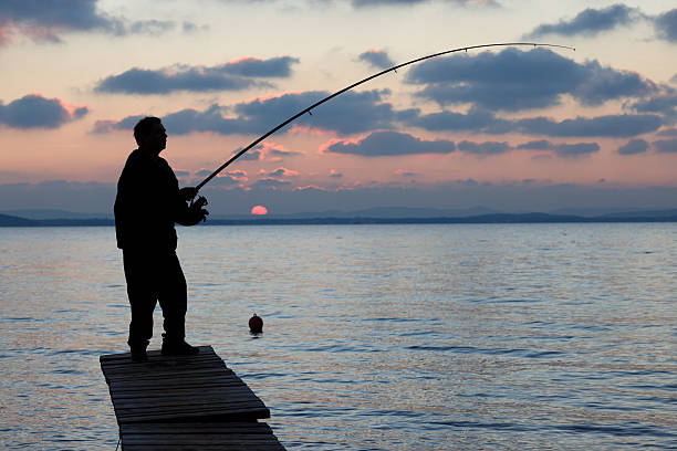 Fisherman on sunset stock photo
