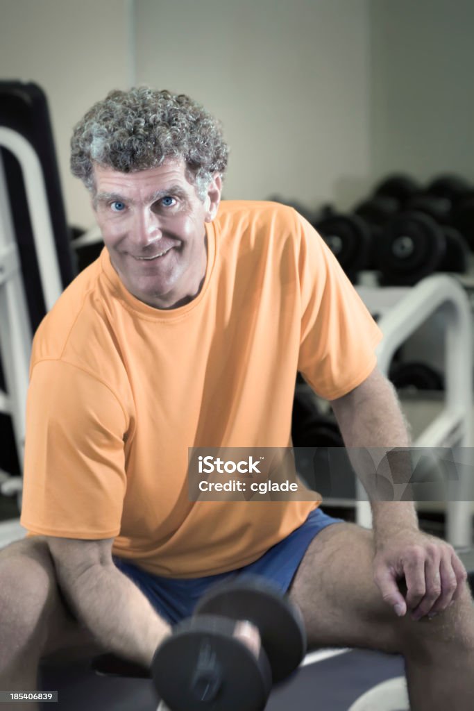 Fitness after Fifty Fit Fifty-three year old male works out with free weights.Related Images: Bicep Stock Photo