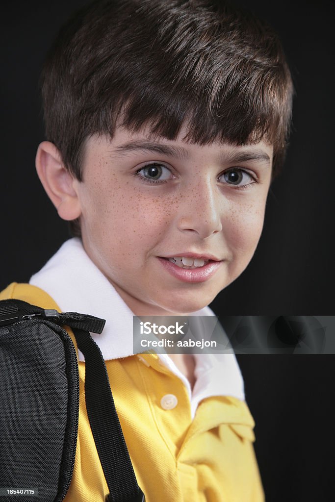 Shy Little boy against a black background. Please view all pictures of this Adolescence Stock Photo