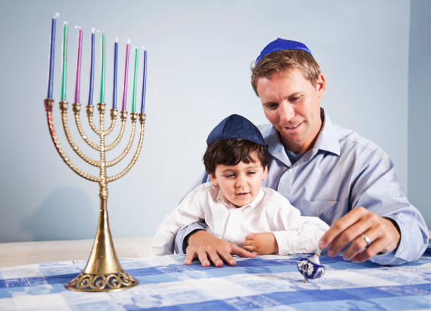 istock Father and boy celebrating Hanukkah 185407152