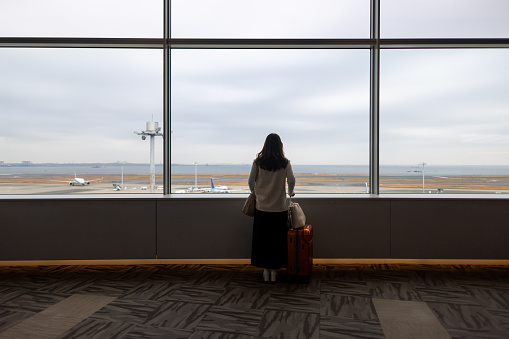 Rear view of woman looking at view from airport